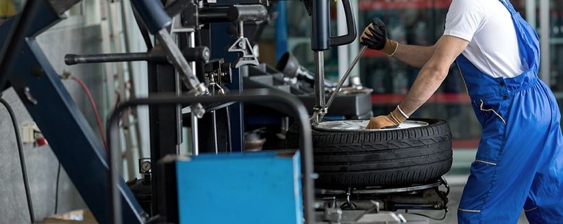 Eine Person arbeitet an einem Autoreifen